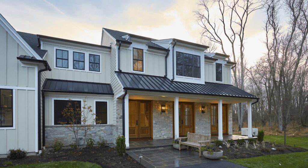 Luxury custom two-story home exterior with porch and large windows